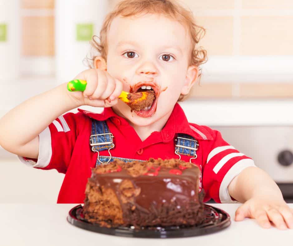 Little boy tucking into a lovely chocolate cake that may have been bought in a Solihull cafe