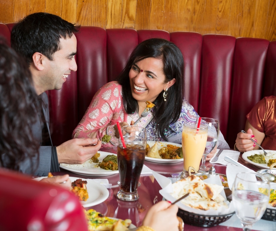indian meal family enjoying an Indian meal in a restaurant