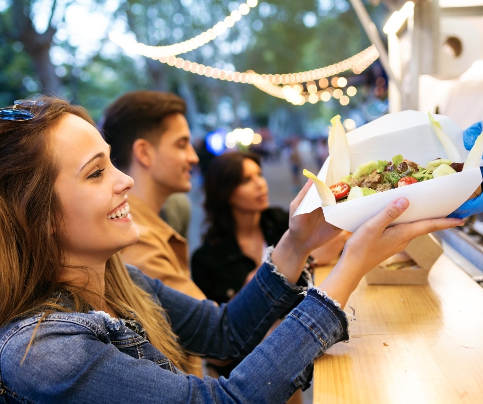 photo of lady buying street food at a festival
