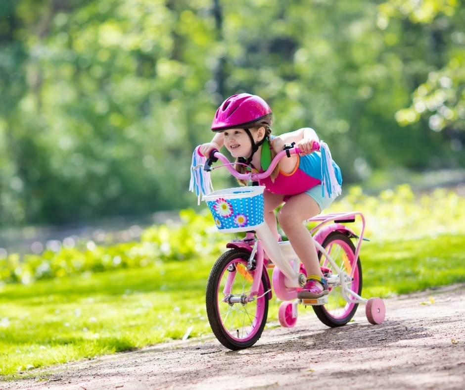 cycling photo of a child riding a bike in a park